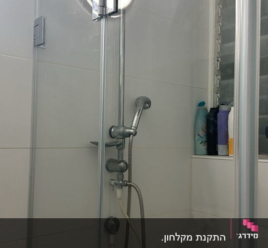 מקלחת עם ראש מקלחת עגול ובקבוקי שמפו